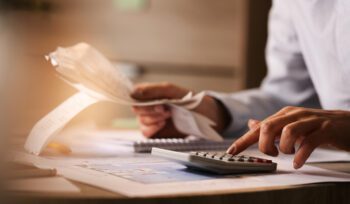 closeup economist using calculator